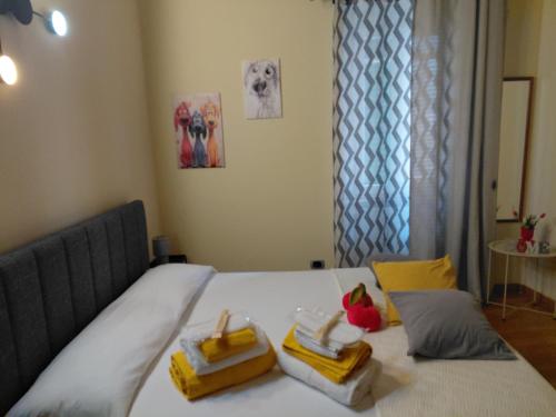 a bedroom with a bed with two towels on it at Berny House in Bracciano