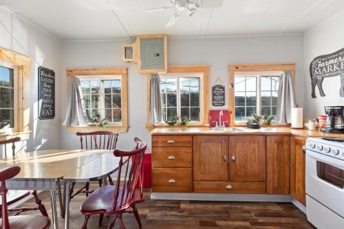 a kitchen with a table and chairs and a dining room at Historic Rockaway Beach Cottage in Rockaway Beach