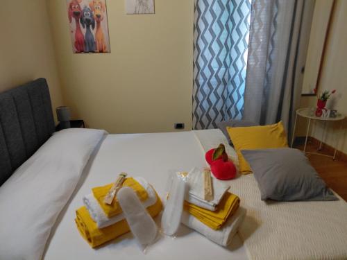a white bed with towels and fruit on it at Berny House in Bracciano