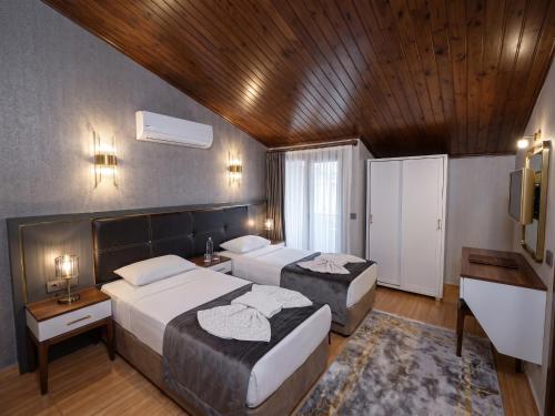 a hotel room with two beds and a sink at Park Marina Hotel in Kemer