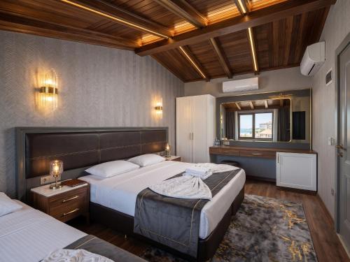 a hotel room with two beds and a television at Park Marina Hotel in Kemer