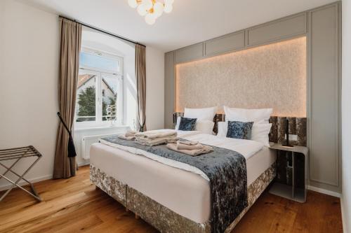 a bedroom with a large bed and a window at Schloss am Bodensee I Private Sauna & Whirlpool in Stockach