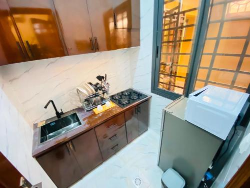 a kitchen with a sink and a stove at Résidence moncloa in Brazzaville