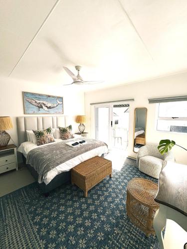 a bedroom with a bed and a couch at House Charisma in Britannia Bay