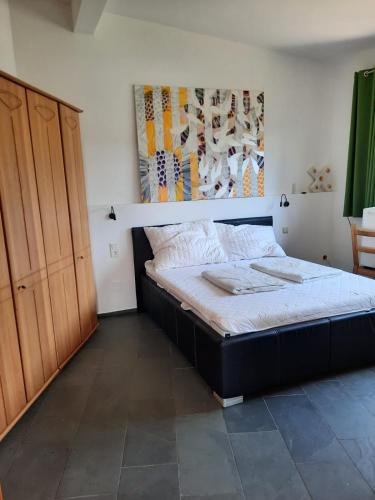 a bedroom with a bed and a wooden cabinet at Wohnung in einer kleinen Burg in Neunkirchen
