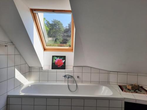 a bath tub in a bathroom with a window at Wohnung in einer kleinen Burg in Neunkirchen