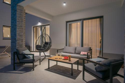 a living room with a couch and a table and chairs at Villa Ginger Modern Villa with Private Pool in Omiš
