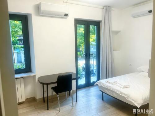 a bedroom with a bed and a desk and a table at Casaxxvaprile in Turin