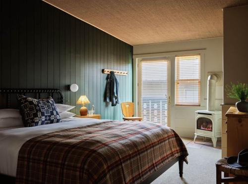 a bedroom with a bed and a fireplace in it at The Alpine House in Jackson
