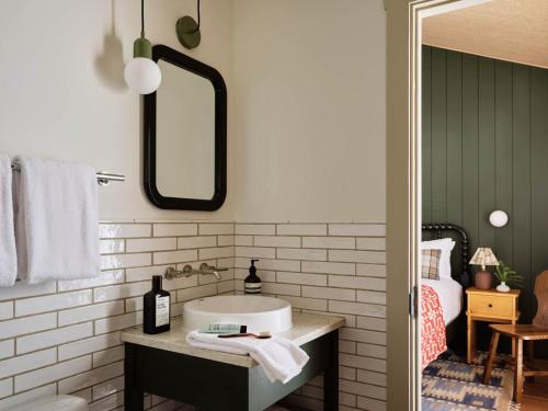 a bathroom with a sink and a mirror at The Alpine House in Jackson