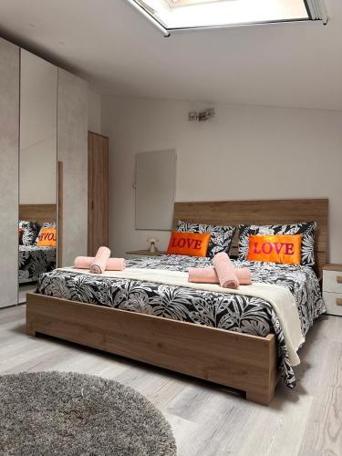 a bedroom with a large bed with orange pillows at Deluxe apartment 2 rooms , near Koper and Trieste in Plavje
