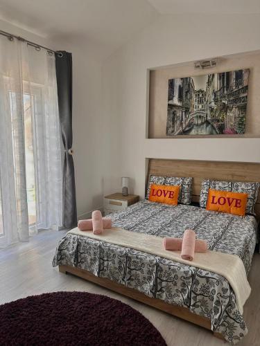 a bedroom with a bed with love pillows at Deluxe apartment 2 rooms , near Koper and Trieste in Plavje
