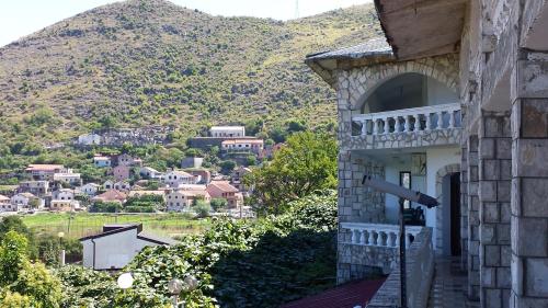 a building with a view of a mountain at Guesthouse Mala Venecija in Virpazar