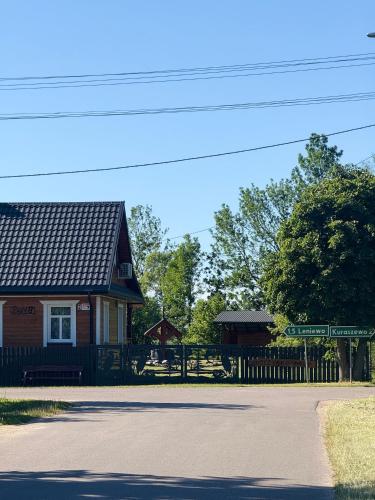 a house with a street sign in front of it at Uroczysko Lady in Lady