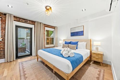 a bedroom with a large bed with towels on it at The West 142nd Street Apartments - Manhattan NYC in New York