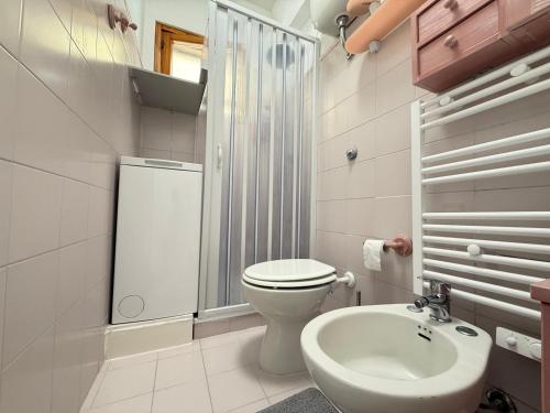 a white bathroom with a toilet and a sink at M473 - Marcelli, trilocale con posto auto e wifi in Marcelli