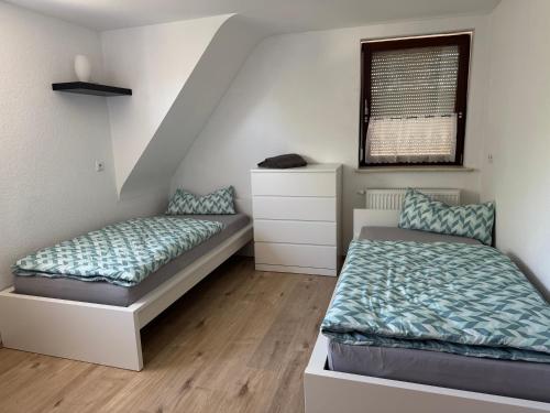 a bedroom with two beds and a window at Ferienhaus Tal in Geislingen