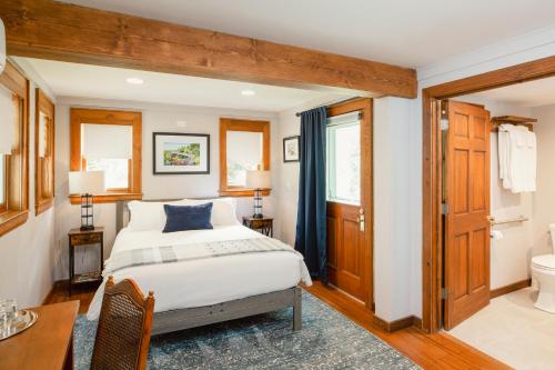 a bedroom with a bed and a bathroom at Lovill House Inn in Boone