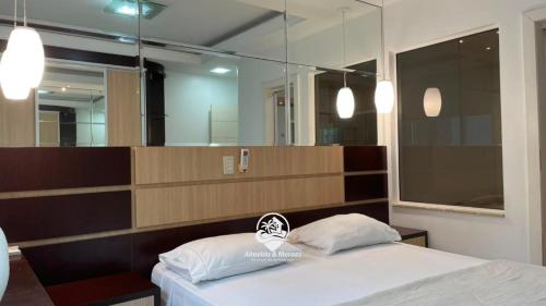 a bedroom with a bed and a large mirror at Apartamento Almeida e Moraes 3 Suítes com Hidro in Itapema