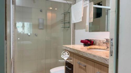 a bathroom with a shower and a toilet and a sink at Apartamento Almeida e Moraes 3 Suítes com Hidro in Itapema