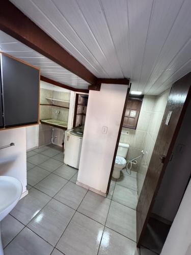 a small bathroom with a toilet and a sink at Hostel amazonia in Búzios