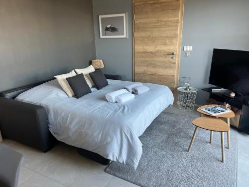 a bedroom with a large bed and a television at Schlof'zheim in Friesenheim