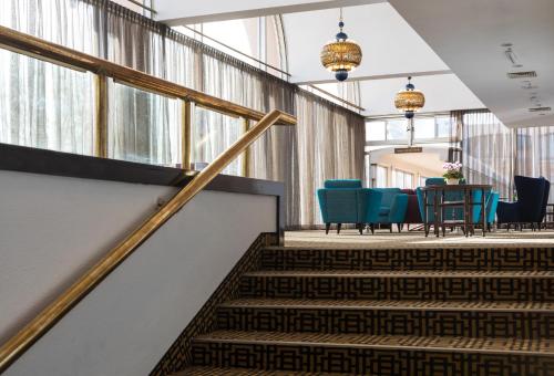 a staircase in a building with a table and chairs at Seven Arches Hotel in Jerusalem