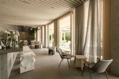 a living room with chairs and a table at Hotel Tulie in Most na Soči