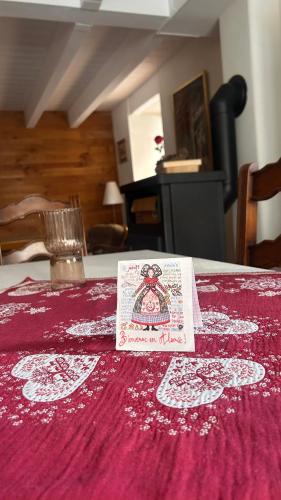 a table with a red table cloth with a napkin on it at Le cordonnier du Staedel in La Petite-Pierre