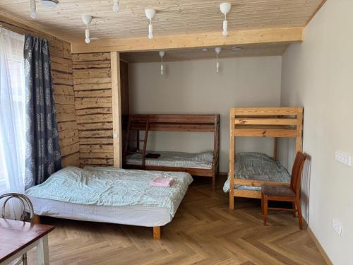 a bedroom with two bunk beds and a chair at ZenTen Apartment in Elva