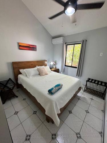 a bedroom with a large bed with a ceiling fan at Private 2 Bedroom Home with Pool Near El Coco Beach in Coco