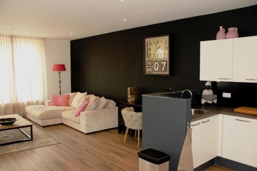 a living room with a couch and a table at Augusta Hotel in IJmuiden