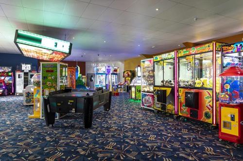 a gaming room with arcade games and a pool table at Seawick Holiday Park in Jaywick Sands