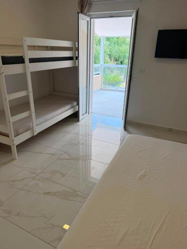 a bedroom with bunk beds and a sliding glass door at Mare D'amare in Diamante