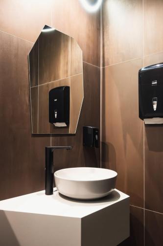 a bathroom with a sink and a mirror at Penzión ZAYDA in Výrava