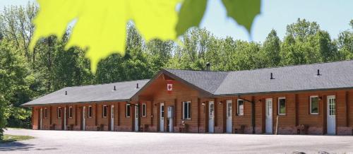 a large wooden building with a lot of windows at Quiet Bay Lakeside Escape in Magnetawan