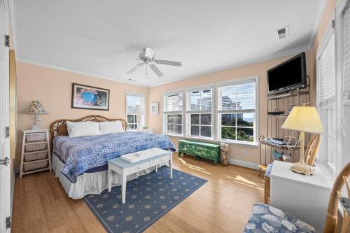 a bedroom with a bed and a flat screen tv at Luxury Waterfront & Oceanfront Beach Paradise in North Topsail Beach