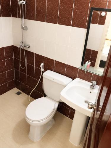 a bathroom with a toilet and a sink at Off Day Inn in Male City