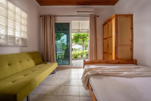 a bedroom with a bed and a couch at Studios Vagelis in Kalamitsi