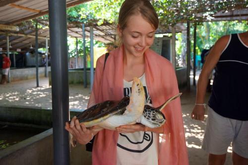 a woman holding a dead bird in her hands at Dhammika Magic Palace in Wadduwa