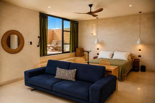 a bedroom with a bed and a blue couch at Olivo Mio in La Paz