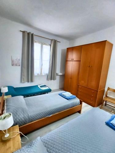 a bedroom with two beds and a dresser at Timo e Lavanda in Albenga