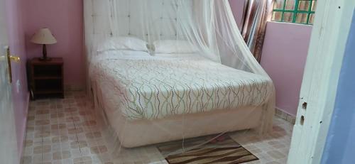 a bedroom with a bed with a canopy at DELIGACY RESORT Eldoret in Eldoret