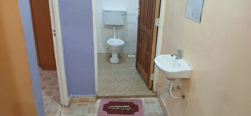 a bathroom with a toilet and a sink at DELIGACY RESORT Eldoret in Eldoret