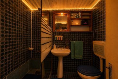 a small bathroom with a sink and a toilet at Casa sol e mar in Colares