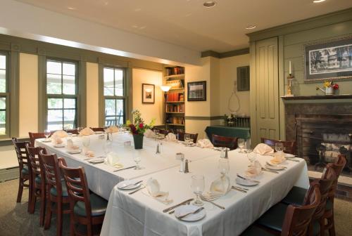 a long table in a room with a fireplace at The Norwich Inn in Norwich
