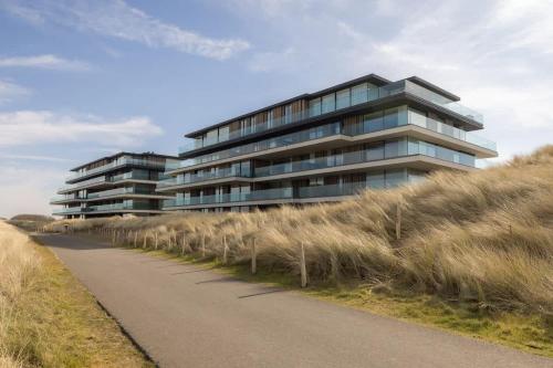 a tall building with a road in front of it at Residence DeBlanke Top - 1D - Cadzand in Cadzand-Bad