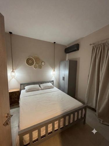 a bedroom with a large bed with white sheets at Geamare Studios in Kálamos