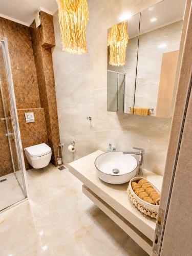 a bathroom with a sink and a toilet and a mirror at Amore Fanari in Fanari