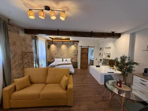 a living room with a couch and a bed at La Flor in El Molar